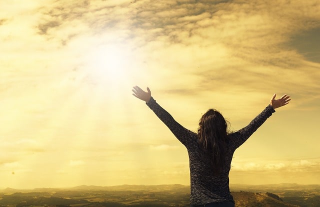 Woman raising her arms in success